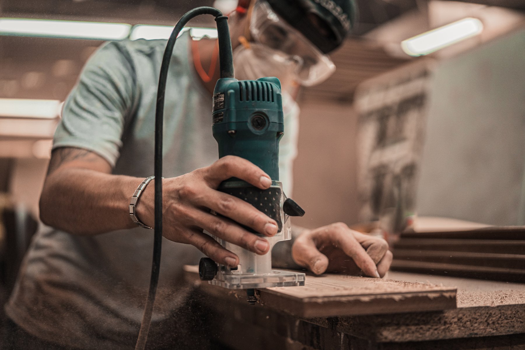 Person Holding Green and Black Power Tool